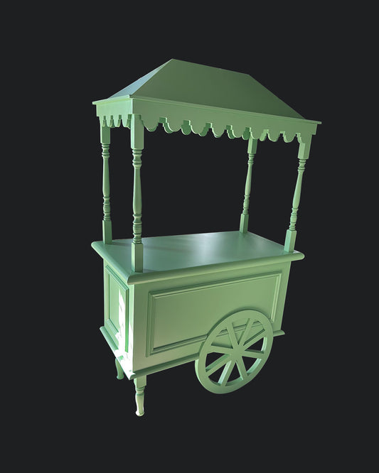 A green sweet cart with a roof, wheels, and a work surface, designed for displaying and serving treats at events.
