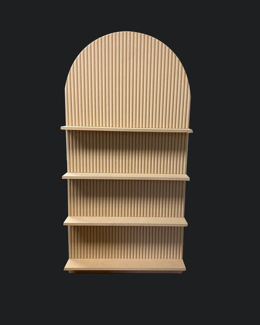 A beige-colored champagne bar backdrop decoration made from MDF, featuring a series of ridged panels arranged in a cascading design.