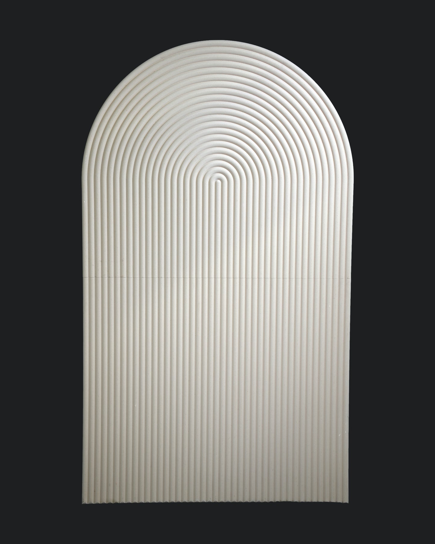 A smooth, oval-shaped backdrop with a rippled design, predominantly white in color against a black background.