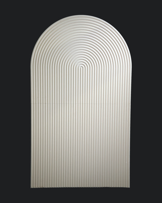 A smooth, oval-shaped backdrop with a rippled design, predominantly white in color against a black background.