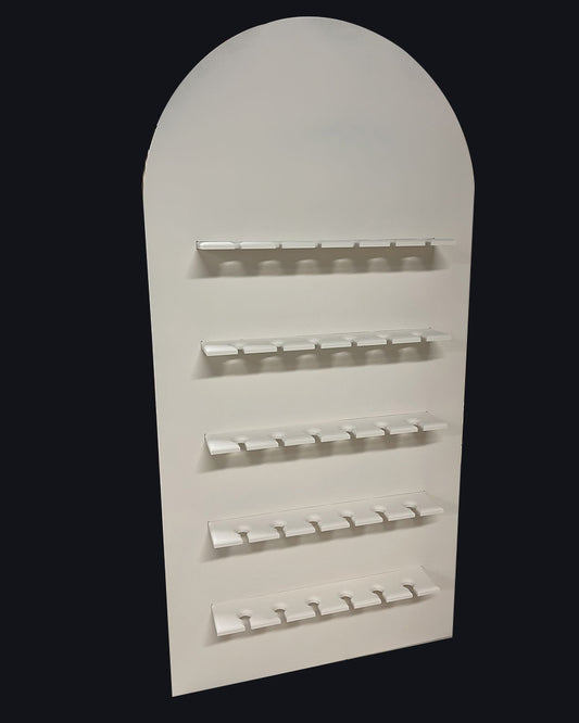 A freestanding, oval-shaped champagne bar backdrop with multiple shelves designed for displaying champagne glasses.