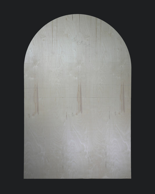 An oval-shaped plain backdrop with a light color, possibly white or beige, intended for use in photography or stage settings.