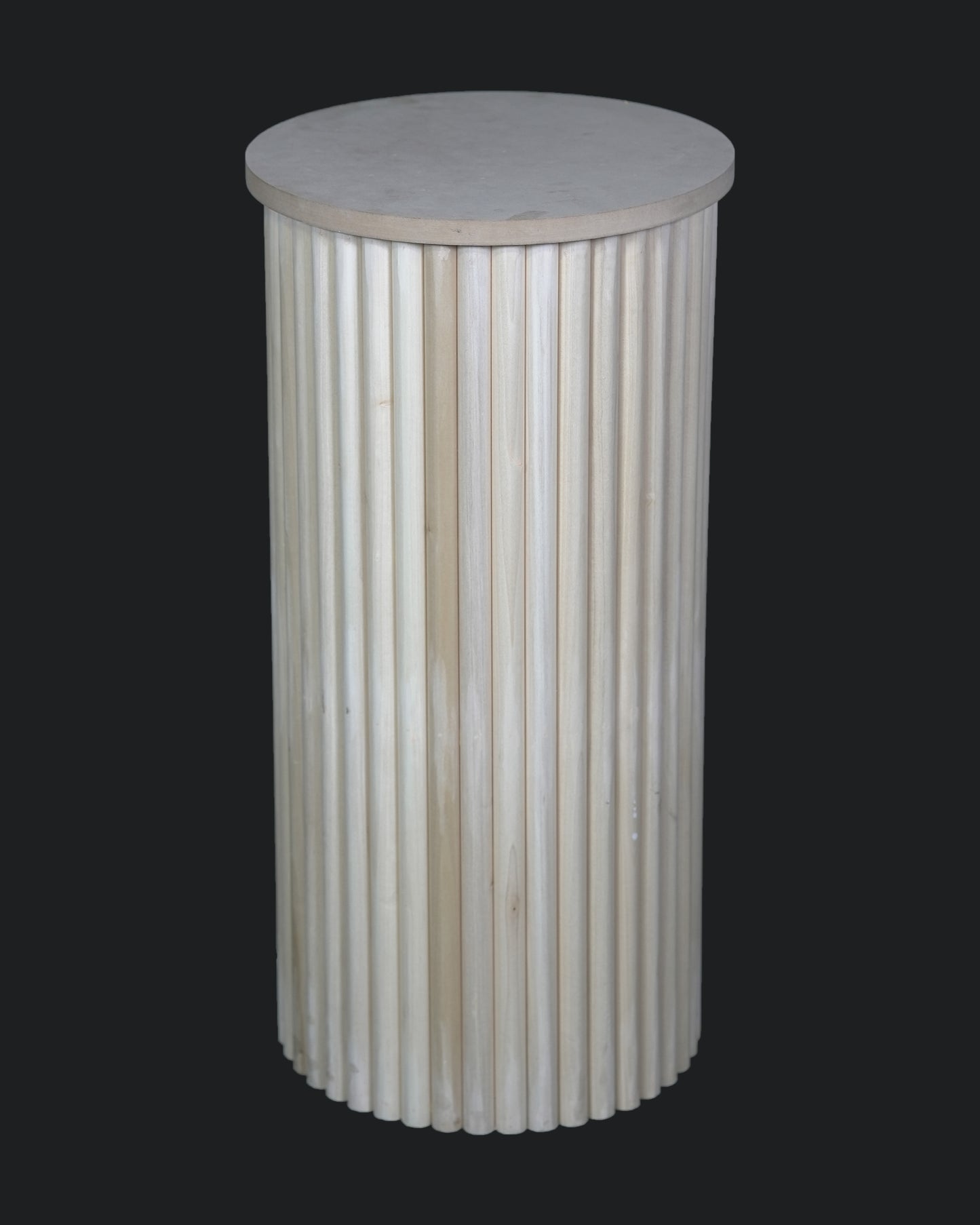 A cylindrical white plinth with a rippled design, suitable for displaying cakes or as a decorative table.