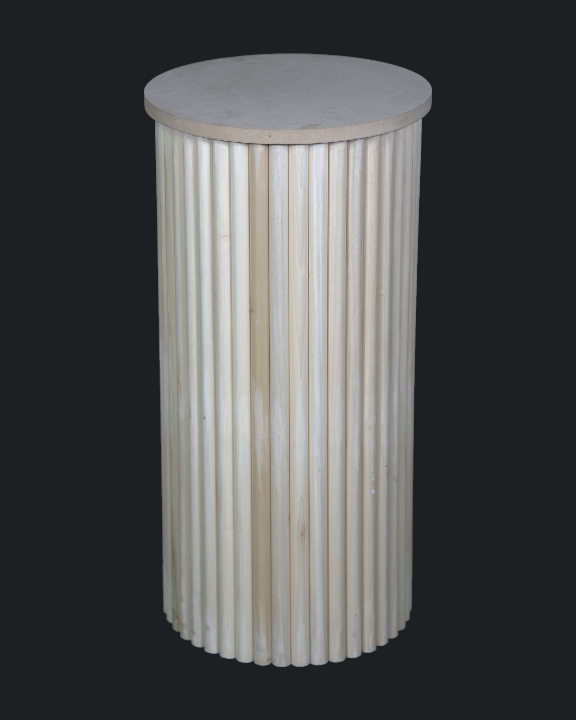 A cylindrical white plinth with a rippled design, suitable for displaying cakes or as a decorative table.