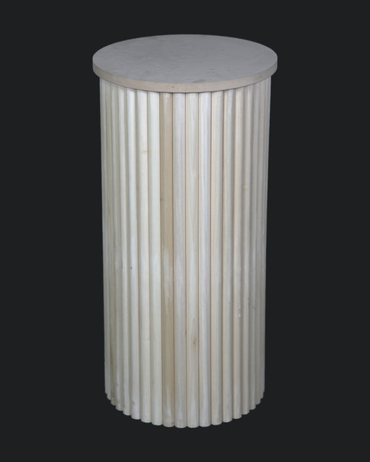 A cylindrical white plinth with a rippled design, suitable for displaying cakes or as a decorative table.